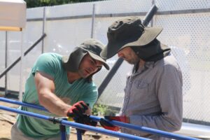 Two people working on setting up the M.A.R.K. system